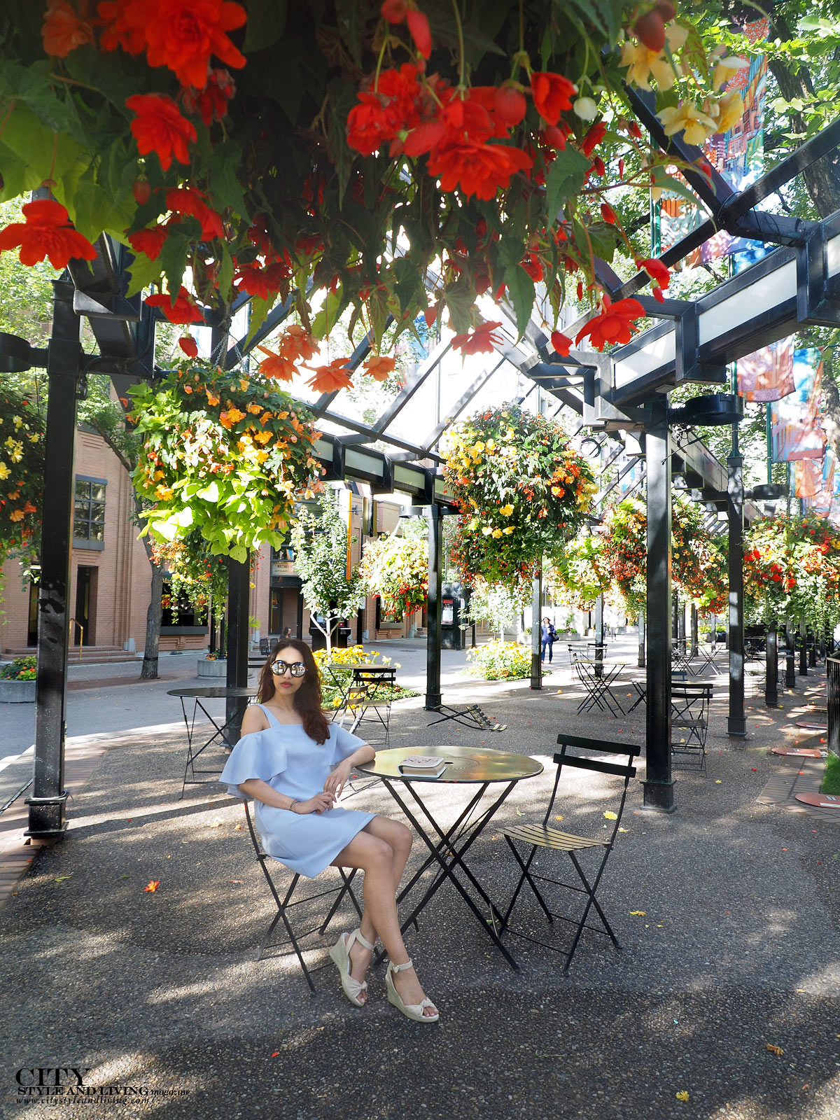 City STyle and Living The Editors Notebook style blogger Downtown Calgary colourful flowers blooming during summer wearing an off shoulder topshop dress and wedges sitting