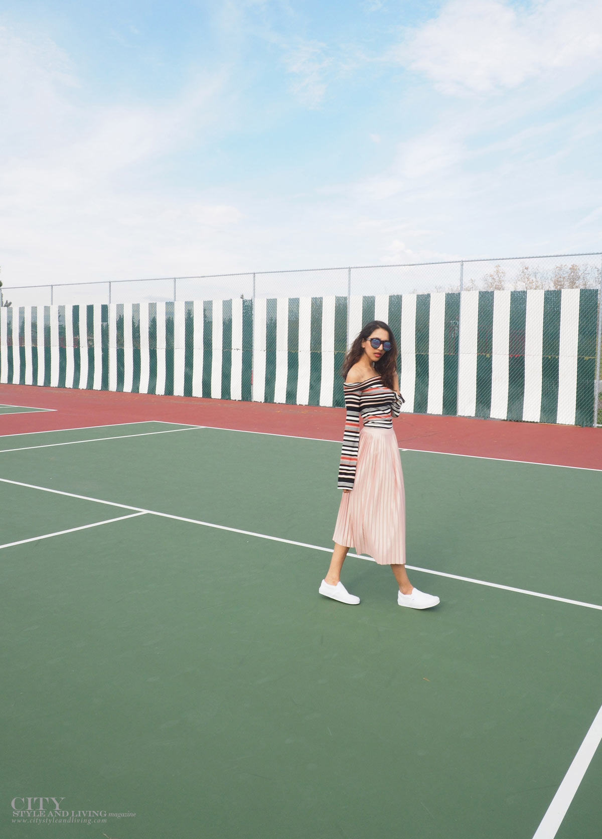 City STyle and Living The Editors Notebook style blogger tennis court topshop metallic skirt, off shoulder free people top, le specs sunglasses and white sneakers and topshop bomber jacket walking on court