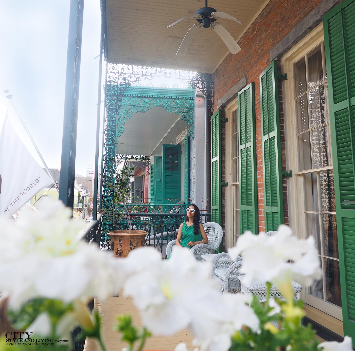 BalconCity style and living magazine The Editors Notebook style fashion blogger Shivana Maharaj French Quarter New Orleans Soniat House Balcony wearing BCBG Max Azria green maxi dress sitting with flowersyFlowerswatermark