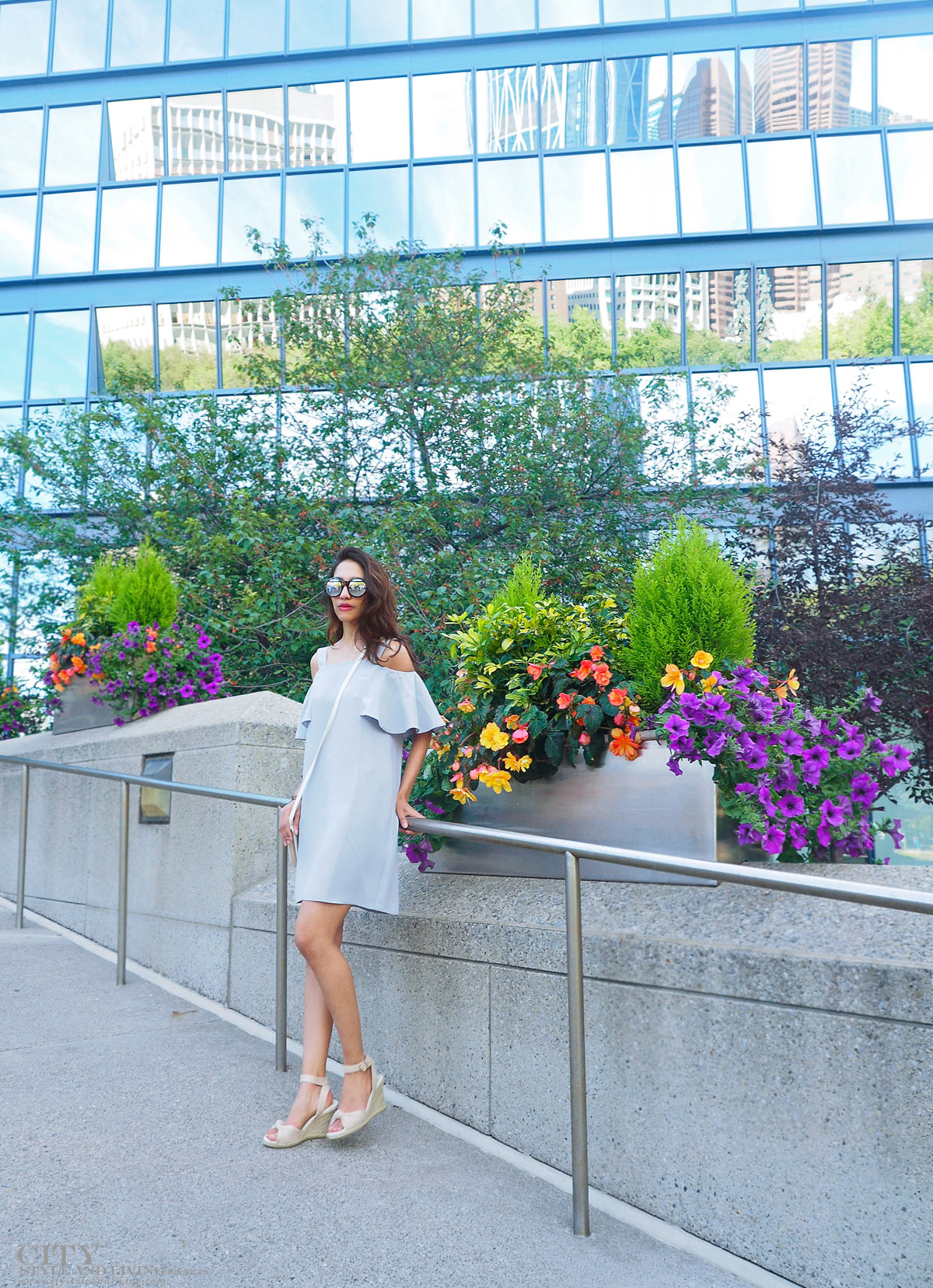 City STyle and Living The Editors Notebook style blogger Downtown Calgary standing colourful flowers blooming during summer wearing an off shoulder topshop dress and wedges